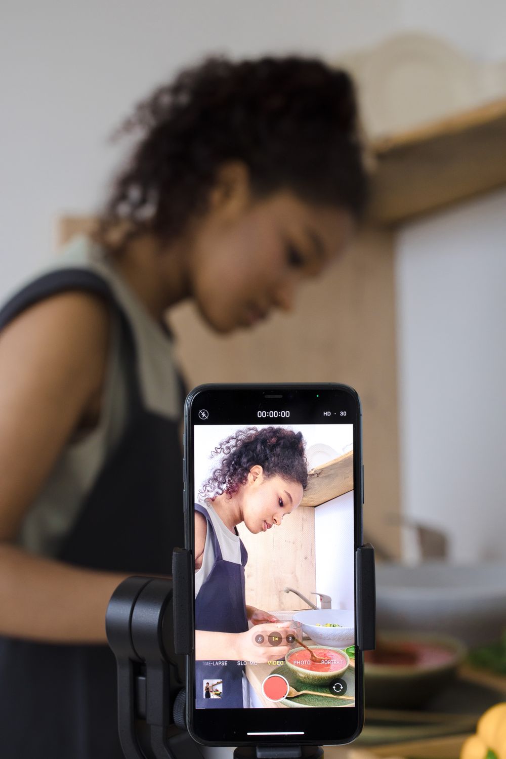 A creator preparing a phone shot — the first step in making the video