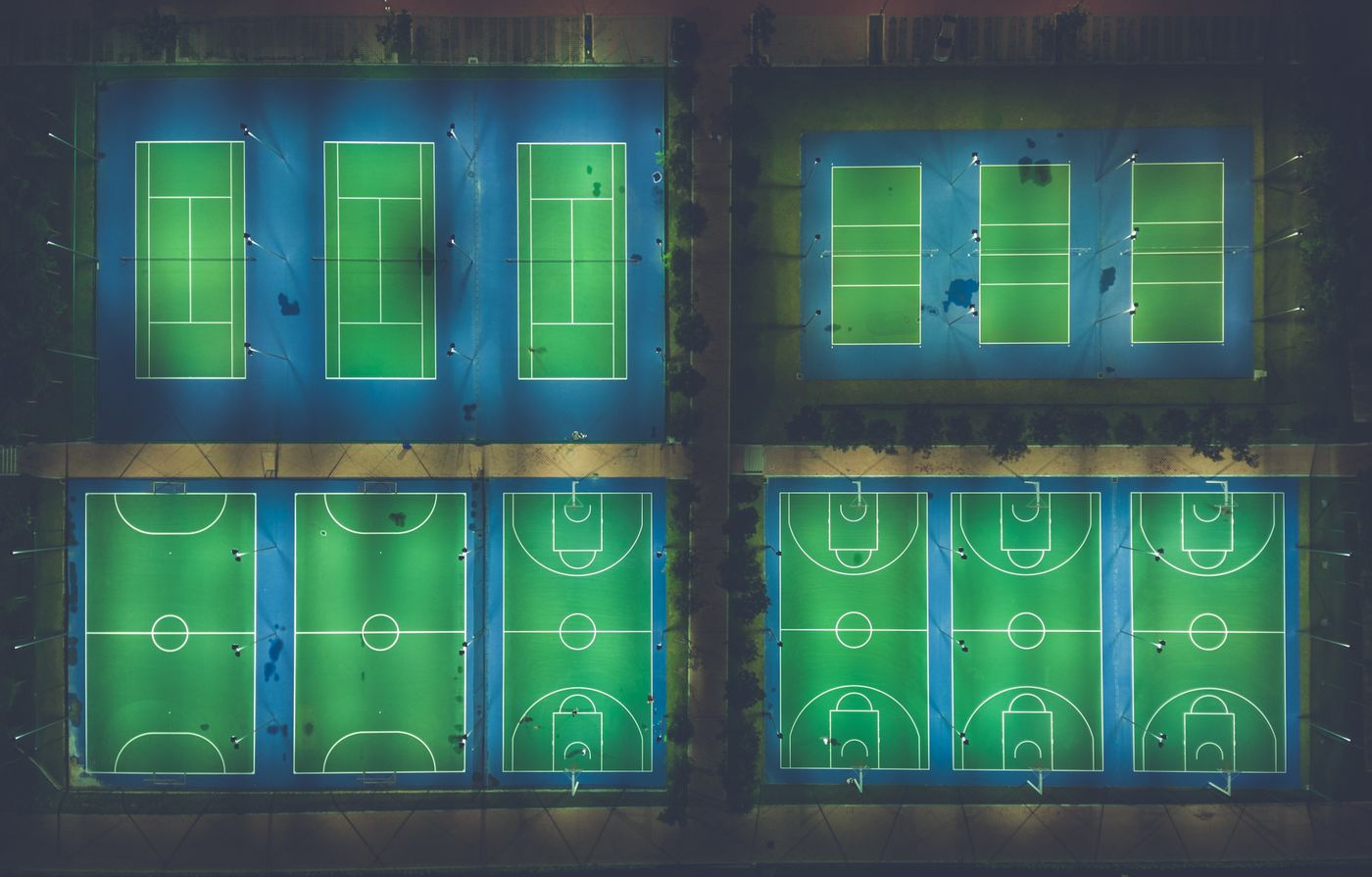 A tennis court at night, the setting of the trend