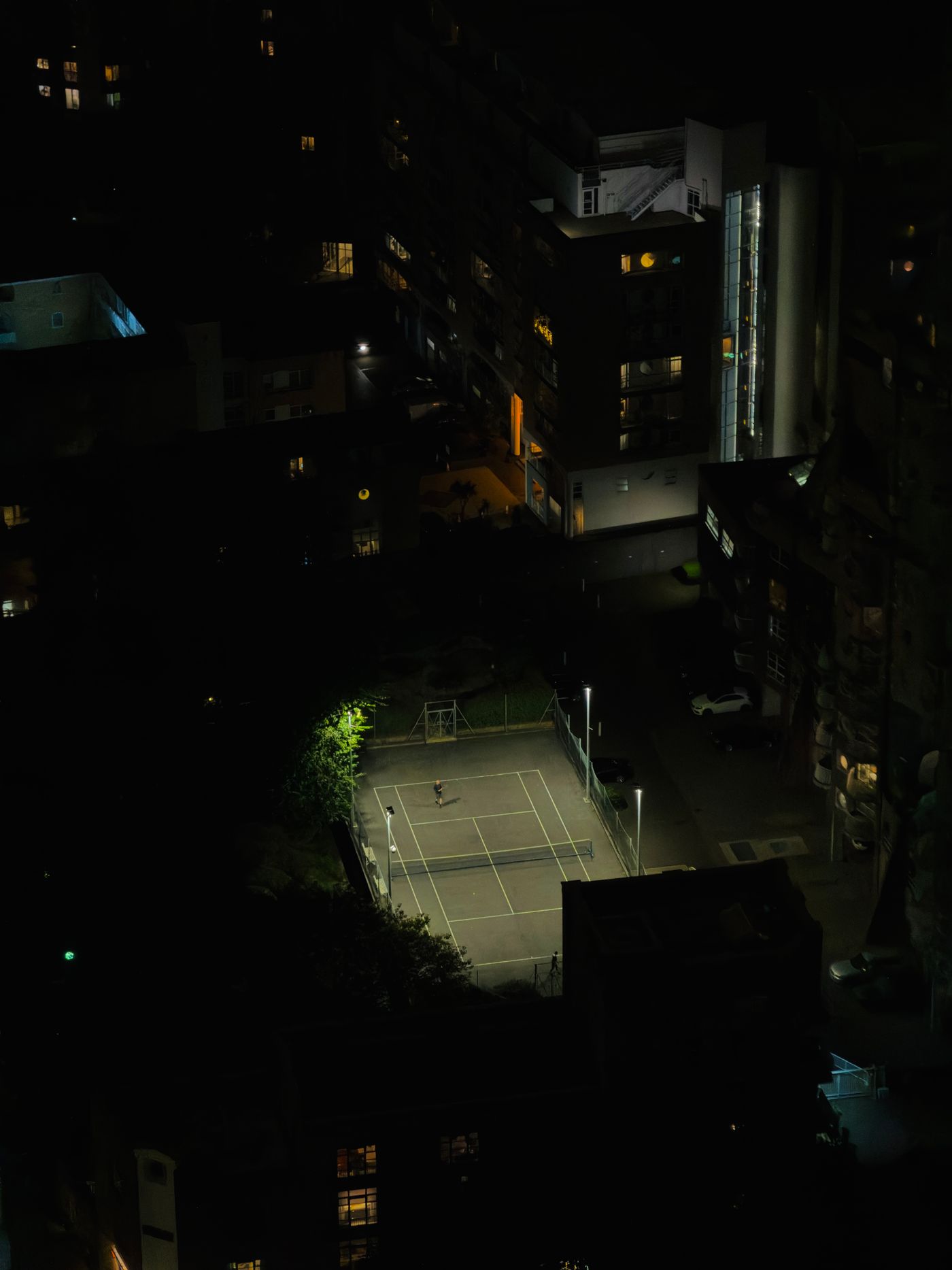 A tennis court under lights at night